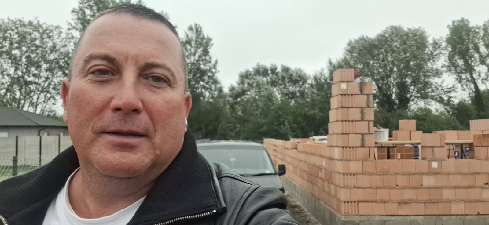 Boross László, építkezésszervező, egy épülő ház előtt